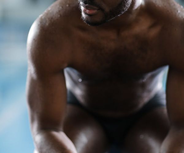 Man looking focused and determined during a challenging strength pose.
